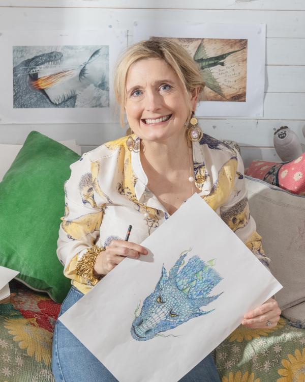 Author Cressida Cowell holds her own illustration of a dragon