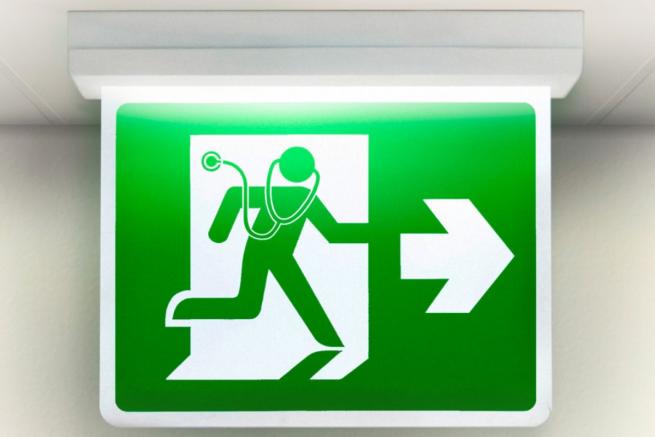 Green exit sign with a stethoscope on the man on the sign.