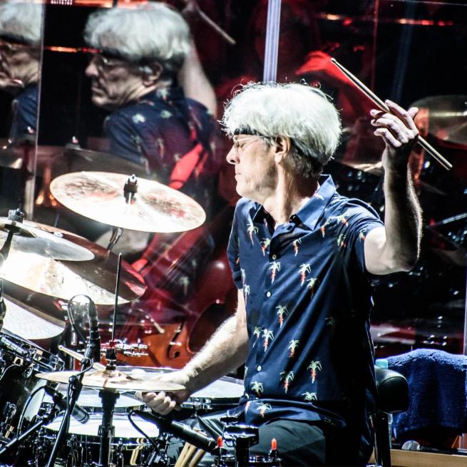Stewart Copeland playing the drums on stage.