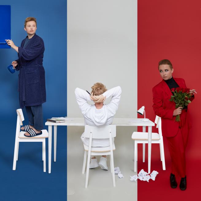 Performer Hannah Maxwell posing infront of a french flag