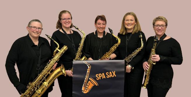 Five female musicians holding their saxophones. 
