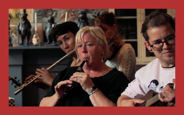 A group of people playing folk instruments together.