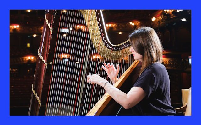 A woman playing the harp.