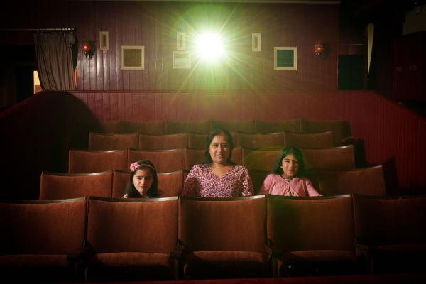 Family sat in cinema chairs