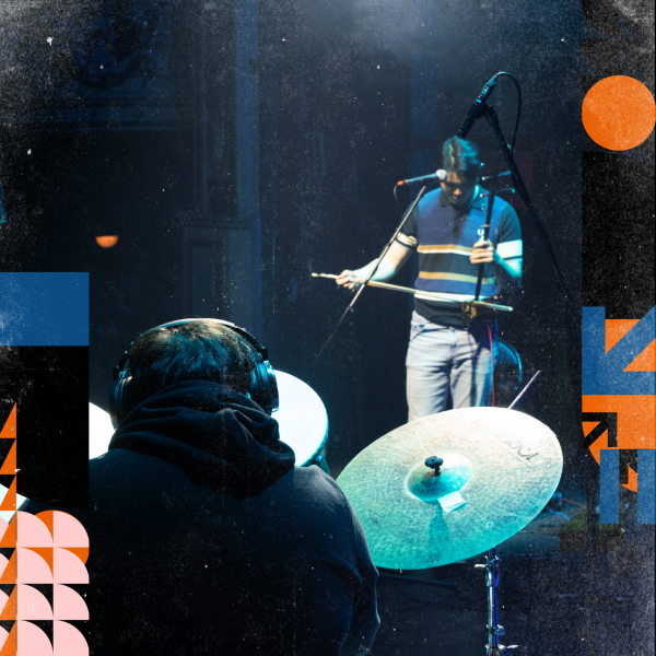 2 musicians playing instruments on stage.