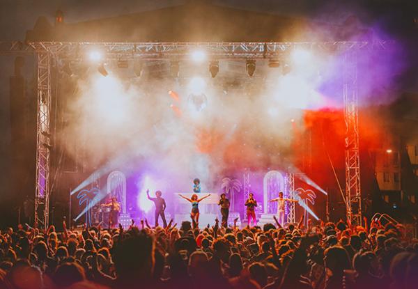 The Brutus Gold's Love Train cast and crew dancing on the Millennium Square stage in front of a crowd of people