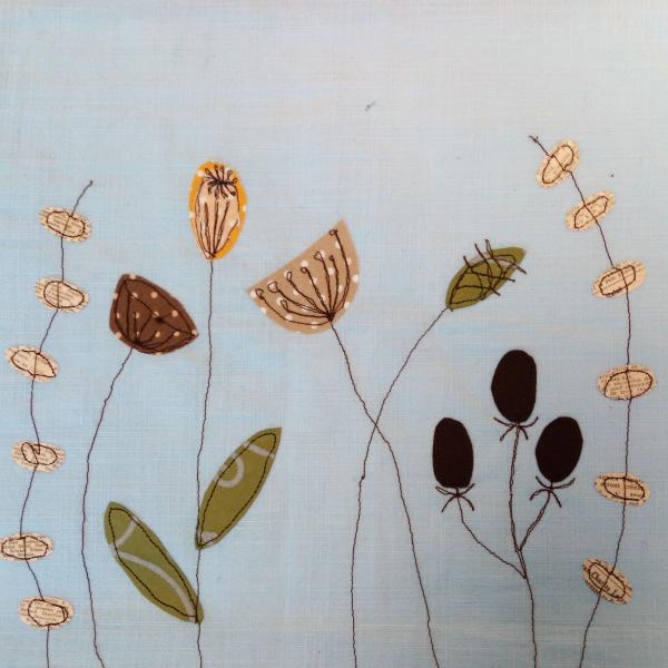 Stitched applique flowers on a pale background