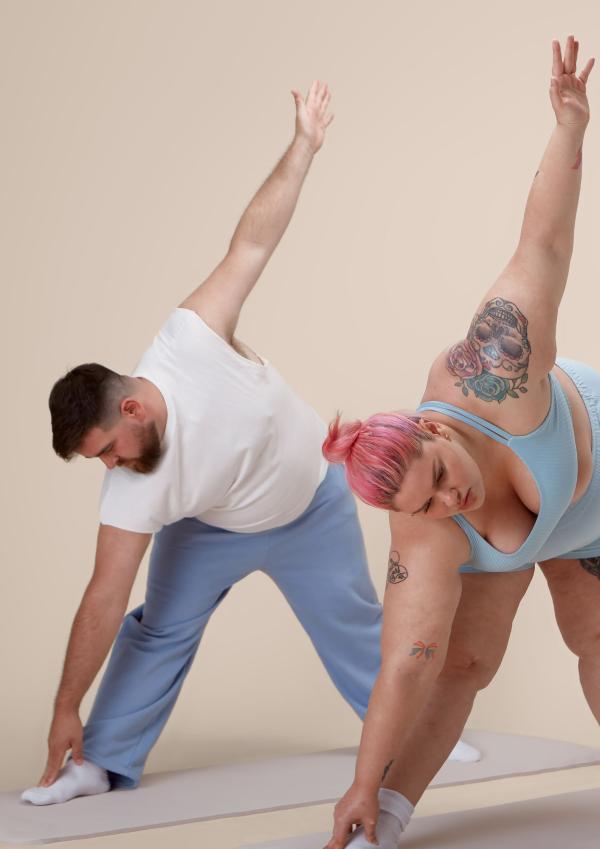 Two people doing dance/yoga stretches 