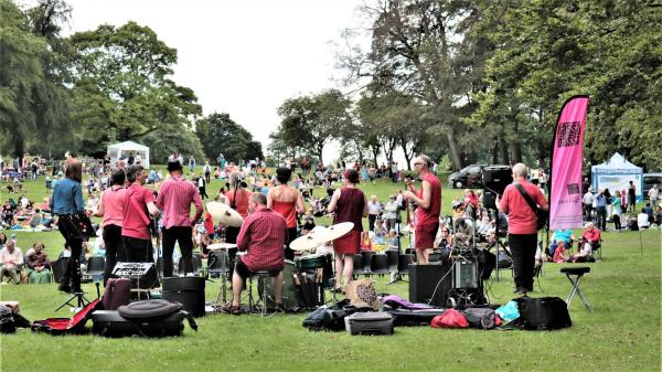 Musicians perform in the park. 