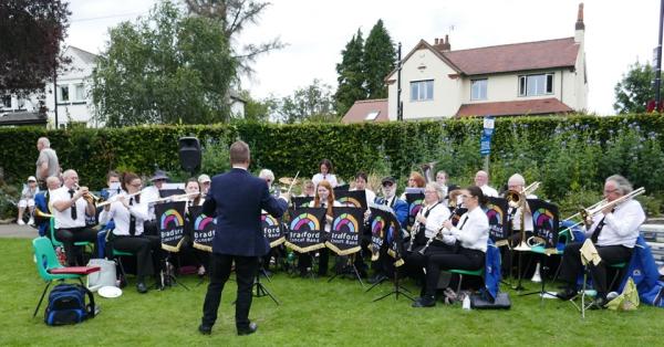 Musicians performing in a park. 