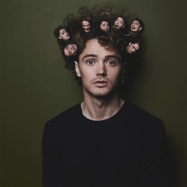 Henry Rowley against a dark green background with a straight face and lots of tiny images of his face in his hair.