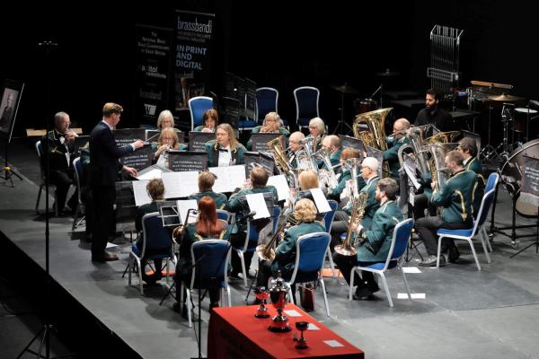 Brass musicians performing on the stage. 