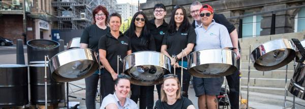 Musicians stood with steel pans. 