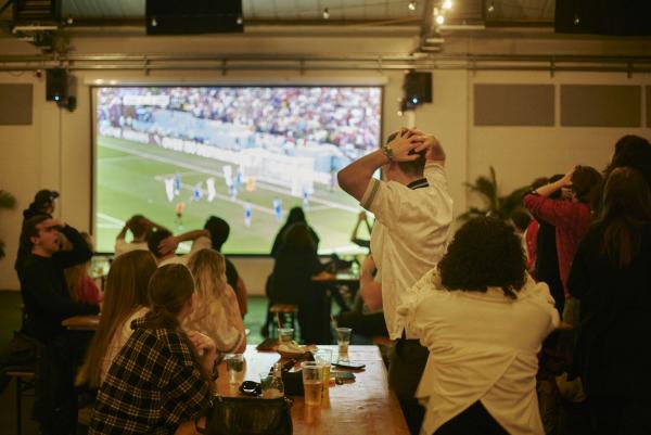 A crowd watches a football match 