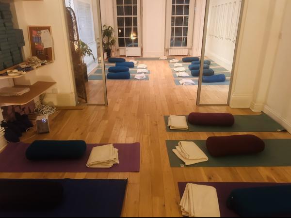 a yoga studio with mats and yoga equipment laid out