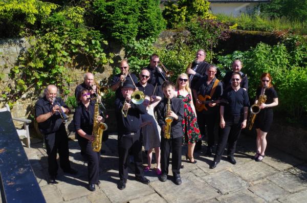 A group of musicians stood in a park. 