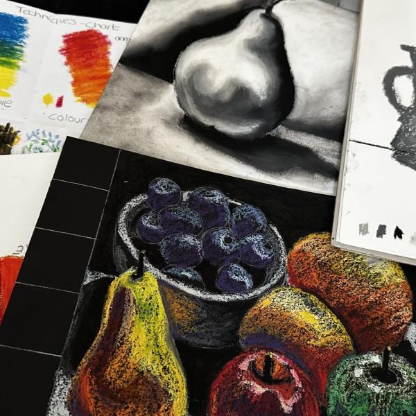 Sketches of fruit, drawn in both black and white and coloured pastels