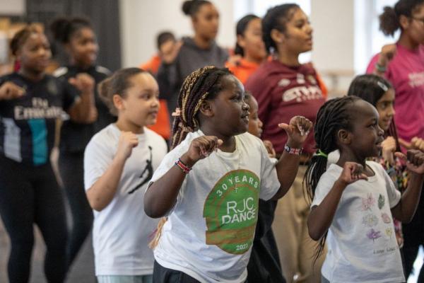 A group of diverse young people dancing.