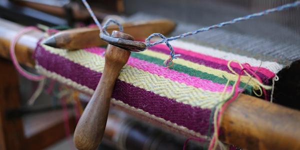 Image Shows a close up shot of a traditional wooden dobby loom