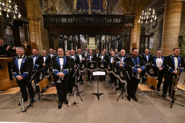 The West Yorkshire Police Band gathered in uniform in a church building
