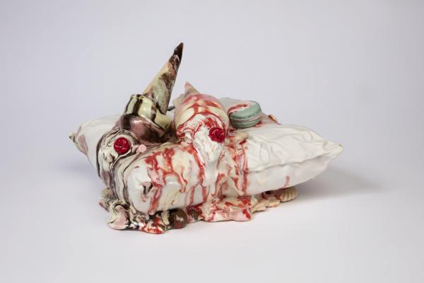 image shows a ceramic melted ice-cream on a ceramic pillow