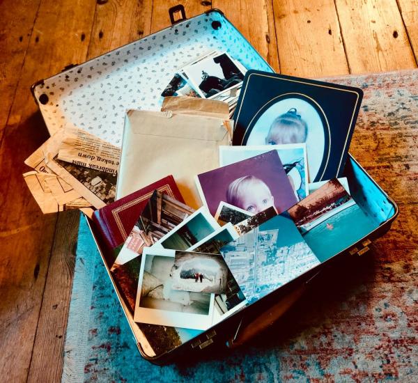 an open suitcase filled with old photographs