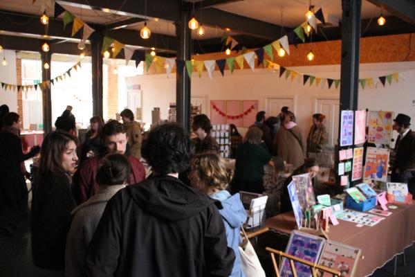 A busy market scene with stalls and customers! 