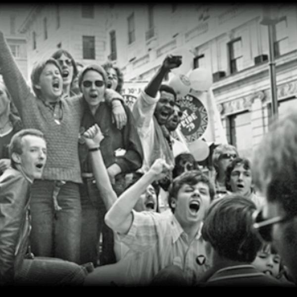 A black and white photograph of protestors at Pride in the 1970s