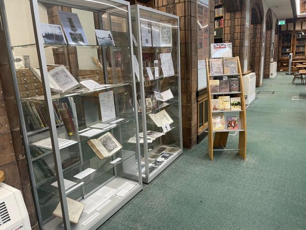 Colour photograph showing a cabinet display in a traditional library setting