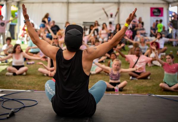 A hip hop dancer teaching a tent full of children