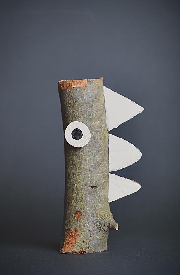 A piece of wood with a cardboard eye and teeth, to give facial features