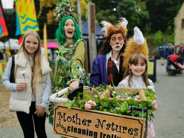 Actors dressed as a mother nature character and a fox