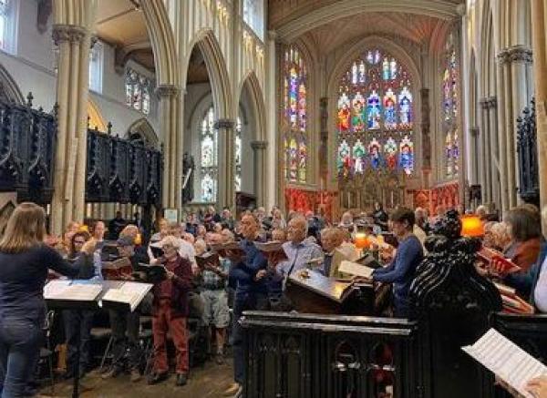 A photograph of people in the cathedral singing.