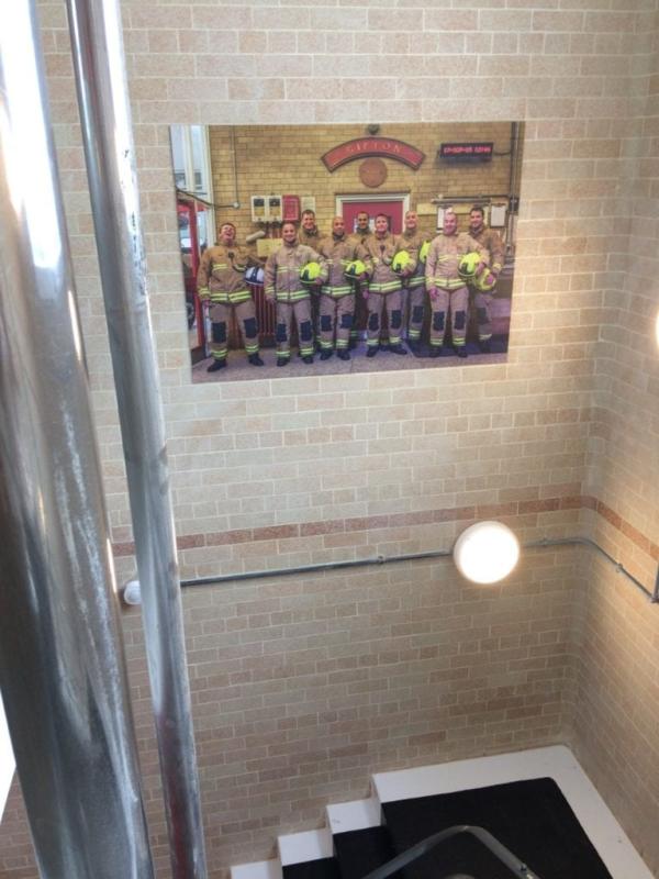 A photograph of fire fighters mounted on the wall at Gipton Fire Station
