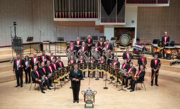 A brass band performing on stage. 