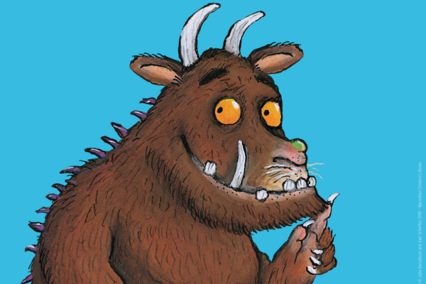 A cartoon image of the Gruffalo, a large brown beast, with horns, yellow eyes, spikes down his back and long sharp teeth.