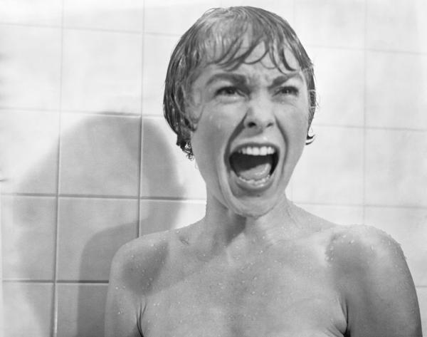 A black and white still from Psycho featuring a screaming Marion Crane played by Janet Leigh.