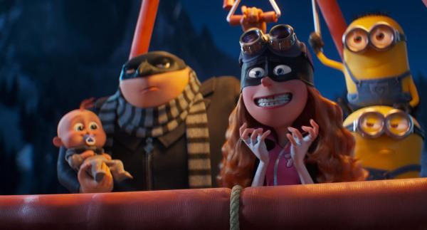 Gru in a mask holding a baby with a woman in a mask are accompanied by two minions