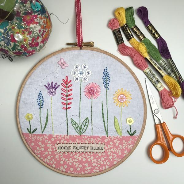 embroidery hoop design with florals made with thread and buttons