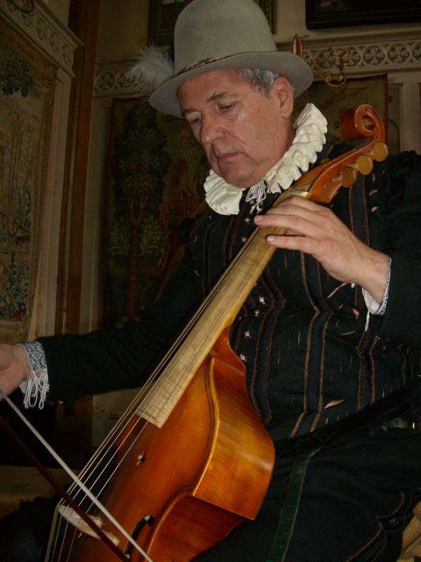 A man dressed in Tudor clothes plays the cello.