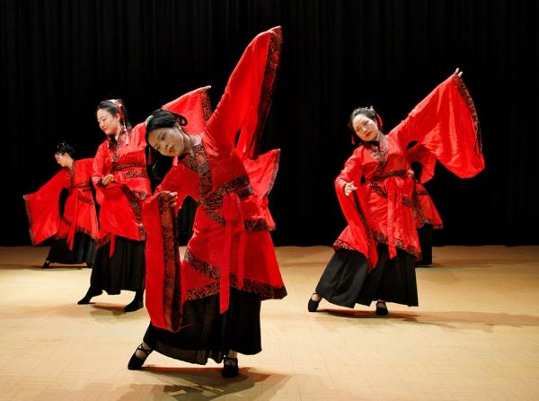 Chinese dancers performing a traditional dance in traditional costumes