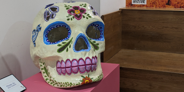 Brightly decorated large model of skull. 