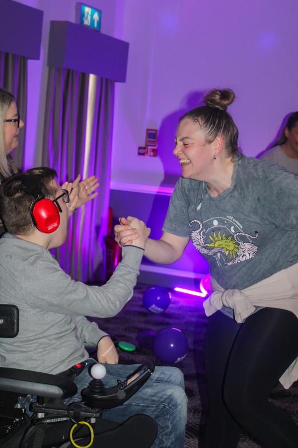 2 people dancing with disco lights