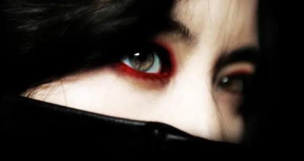 Close up of Lady Vengeance with just her eyes and red eye make up around her green eyes 