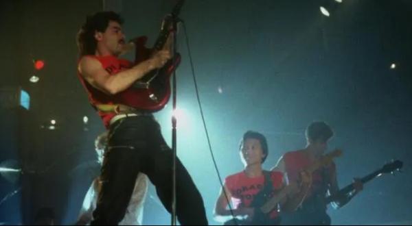 Rock band dressed in red and black playing guitars