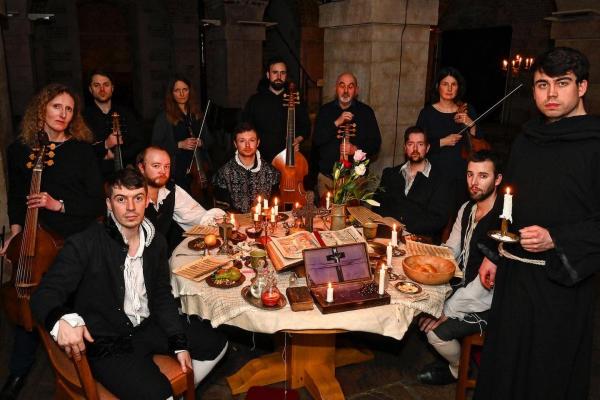 Musicians sat round a round table.  