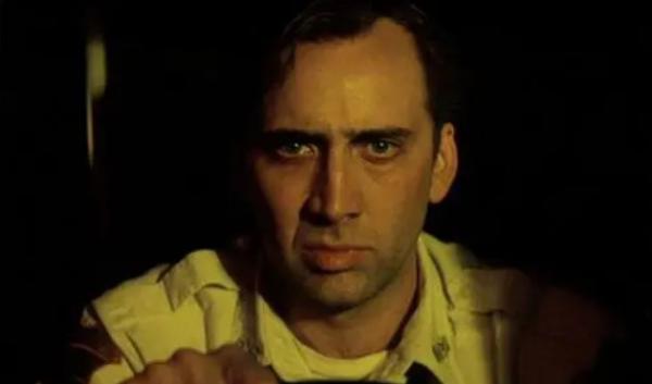 Nicolas Cage as Frank Pierce as he is driving the ambulance and staring intently