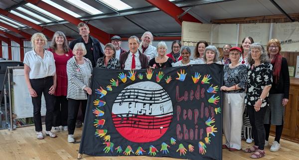 Picture of Leeds People's Choir with their choir banner