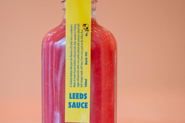 A close up of a pink bottle of Leeds Sauce