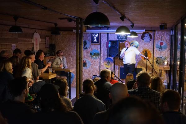 Local comic Mick Tickner delivering a solid set to a full room at piglove by the river. 